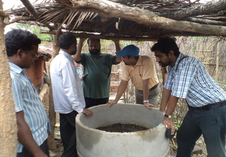 Inspecting vermin pits by Mennonite Central Committee officers